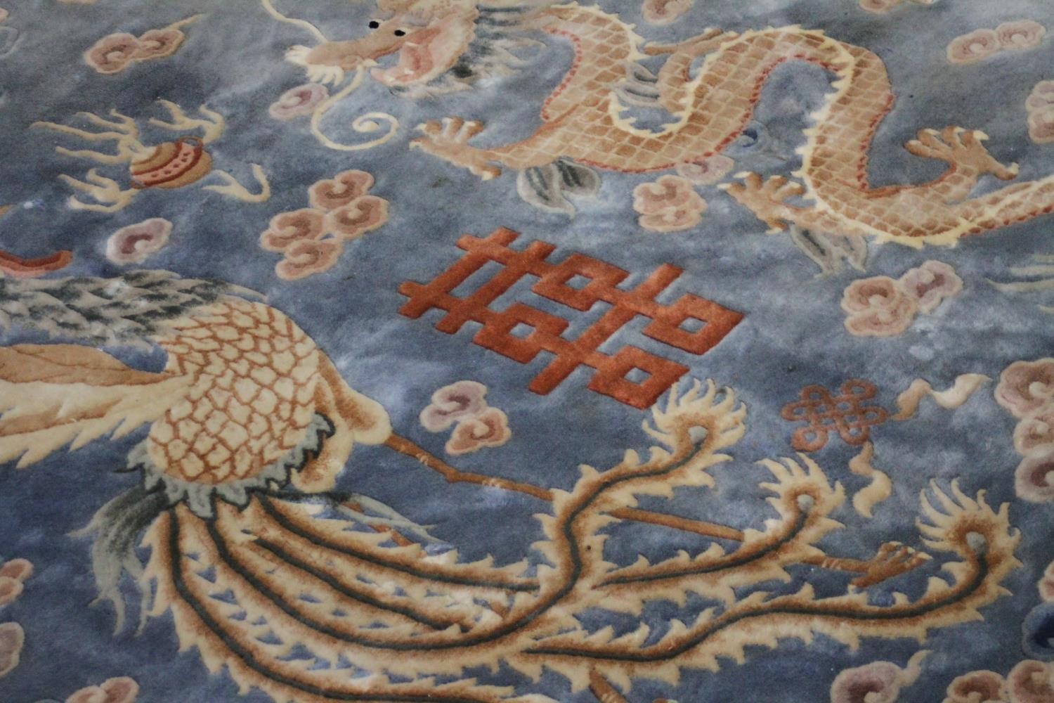 A Chinese carpet with chasing dragon and character motifs on a powder blue ground within a - Image 3 of 8