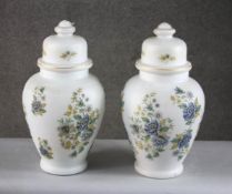 A pair of vintage frosted milk glass floral design lidded jars converted into table lamps. H.46