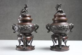 A pair of Chinese Qing dynasty bronze lidded censers with dragon design. H.25 Diam.16 cm.