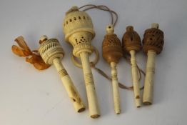 Five Victorian bone rattles. Three turned bone and vegetable ivory rattles/whistles and two turned