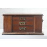 A late 19th century walnut Elkington table top canteen cabinet with locking stiles and twin brass