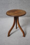 A 19th century rosewood occasional table with central satinwood inlaid fan patera on shaped and