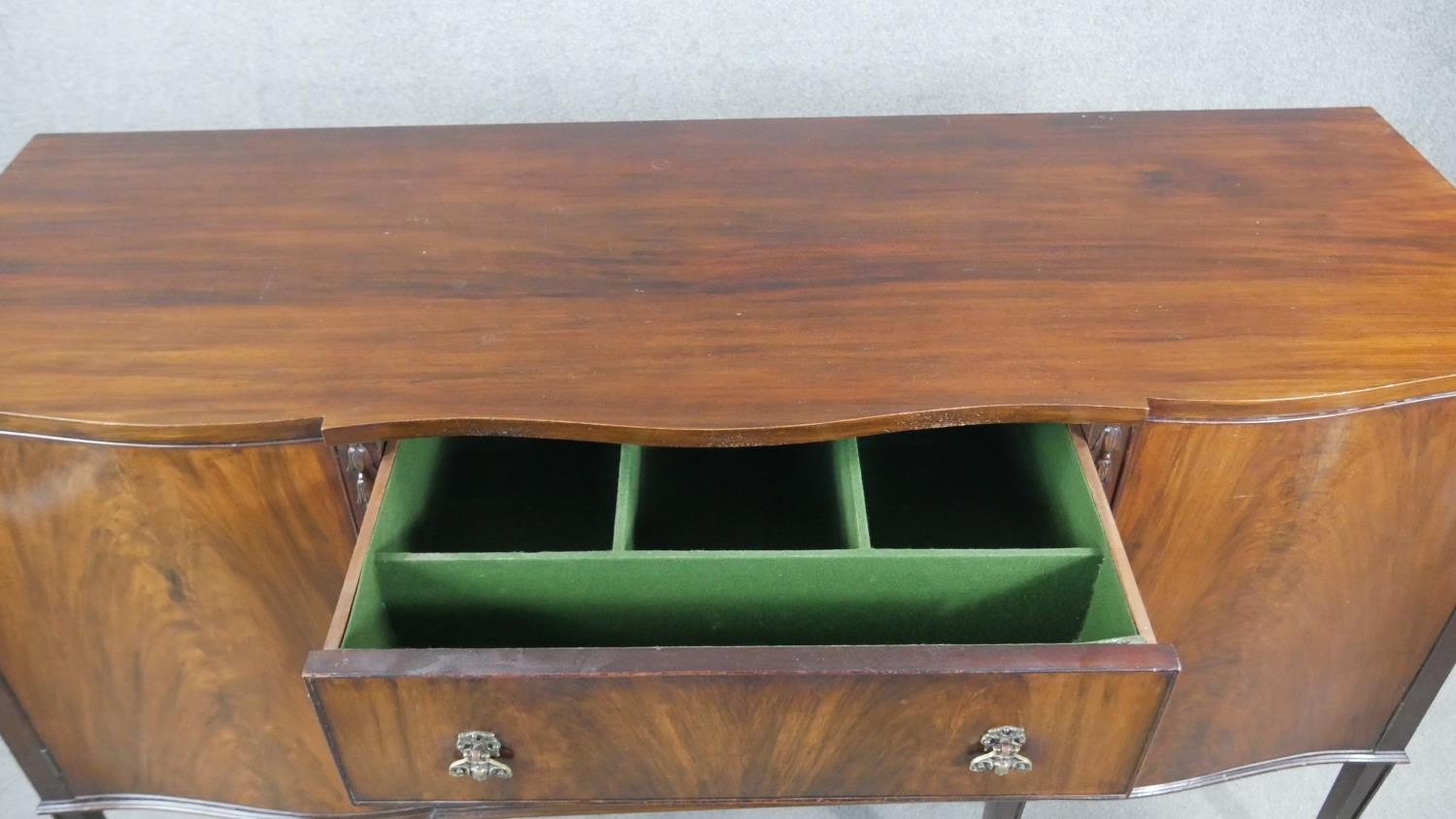 A Georgian style flame mahogany sideboard with husk carved decoration on square tapering supports. - Image 4 of 8