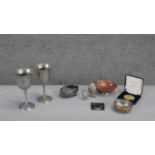 A collection of metal ware. Including two pewter goblets, two silver plated owls and other items.