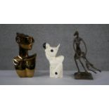An Art Deco ceramic minstrel vase, a bronze effect moulded figure of a mother swinging her child and