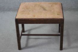 A 19th century mahogany stool with drop in seat on square stretchered supports. H.62 W.52 D.38 cm.