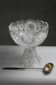 A large early 20th century hand cut crystal punch bowl and stand with star design along with a