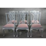 A set of six painted Chippendale style dining chairs with carved and pierced splat backs above