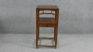 A 19th century Chinese teak urn stand or lamp table on square supports united by under tier fitted