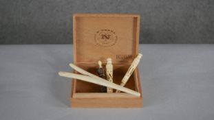 A collection of 19th century carved bone sewing instruments and a glove stretcher. Including two