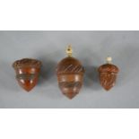 Three 19th century coquilla nut acorn design thimble holders. Each with a repeating foliate design