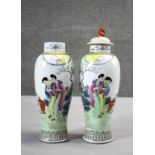 A pair of Famille Rose Chinese hand painted porcelain jars with lids (one missing), decorated with