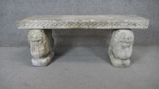 A Classical style concrete garden bench with platform seat on twin lion supports. H.47 W.120 D.40