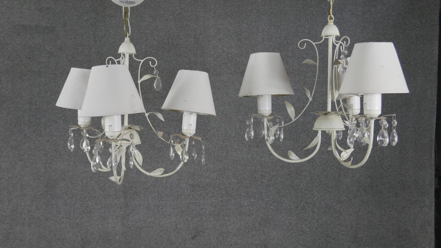 A pair of toleware foliate design three branch chandeliers with crystal drops. H.40 W.42cm