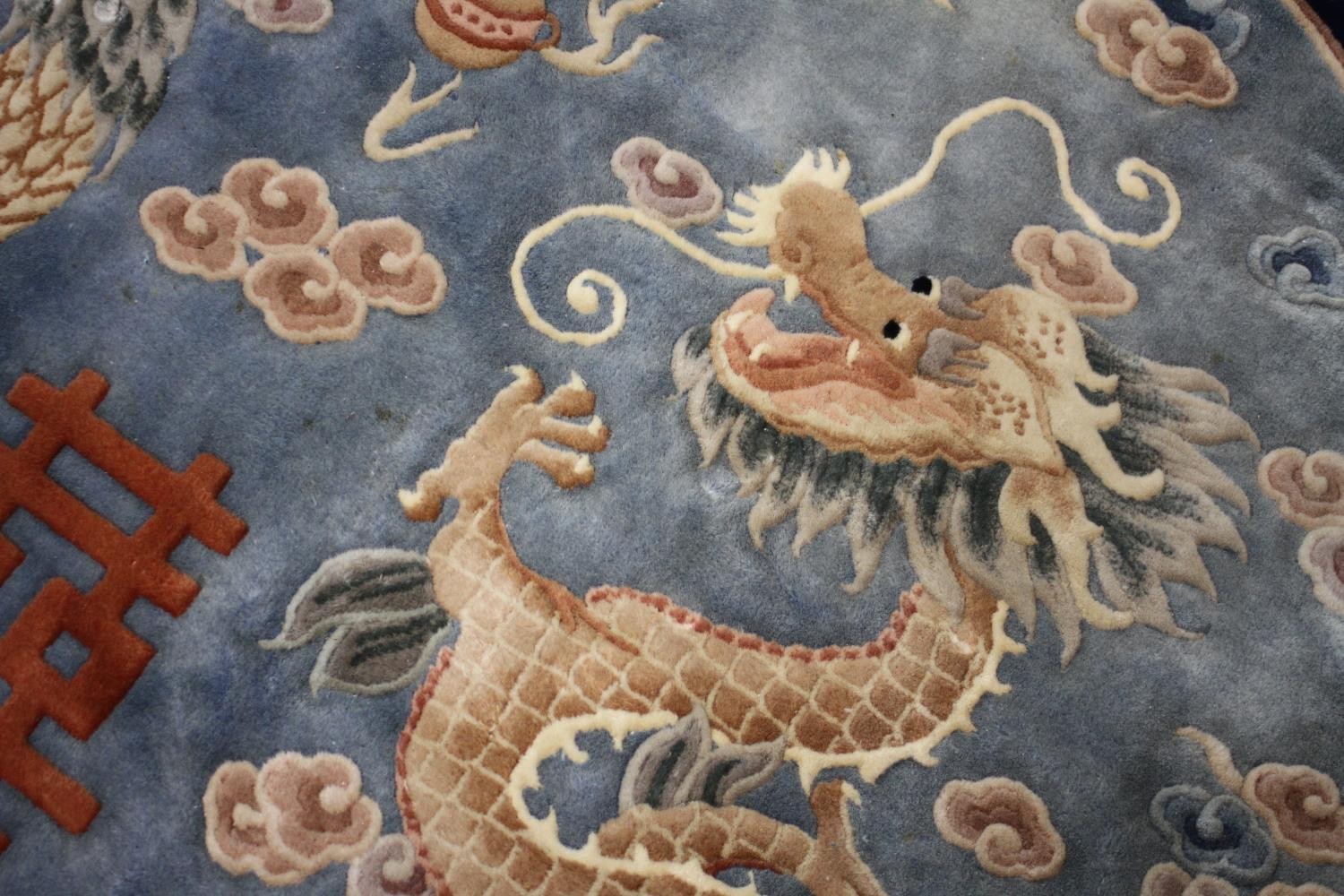 A Chinese carpet with chasing dragon and character motifs on a powder blue ground within a - Image 6 of 8