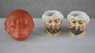 A pair of hand painted porcelain humidors in the form of an Arab man in a turban (lids missing)
