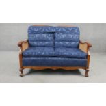 A mid century beech bergere sofa with caned back and sides on carved cabriole supports. H.80 W.113