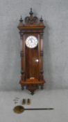 A 19th century German walnut Vienna regulator wall clock with white enamel dial with black Roman