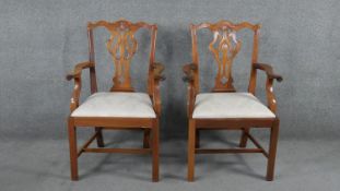A pair of mahogany Chippendale style open armchairs with drop in seats on square stretchered