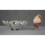 A carved vintage conch shell light with a female portrait and flower decoration on a gilt metal