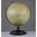 An early 20th century Philips' 12" Terrestrial Globe on ebony stand, no.2615, showing 'Principal