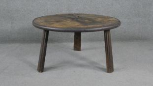 A hardwood metal bound low table on tripod supports. H.46 Diam.84cm
