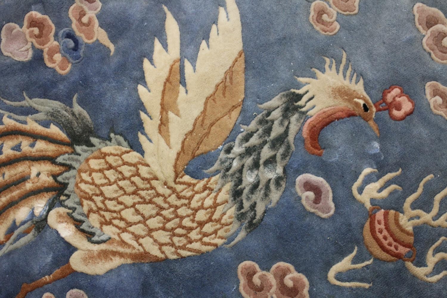 A Chinese carpet with chasing dragon and character motifs on a powder blue ground within a - Image 7 of 8