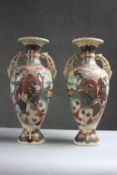 A pair of 19th century twin handled Japanese Satsuma ware vases. Decorated with warriors on one side