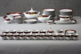 A Thun Czech porcelain twelve person part dinner set in maroon and gilt fruit design. Comprising