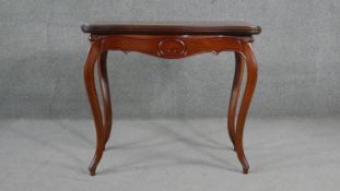 A late 19th century Continental walnut tea table with fold over top on hinged gateleg action on