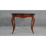A late 19th century Continental walnut tea table with fold over top on hinged gateleg action on