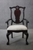 An 18th century style mahogany armchair with floral damask upholstered seat on cabriole ball and