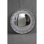 A Regency style convex wall mirror in ball decorated silvered moulded frame. 50cm diameter.