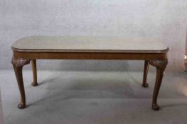 A mid century burr walnut Epstein dining table with plate glass top on carved cabriole supports. H.