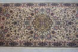 A Persian motif rug with central floral medallion. L.140 W.68cm.