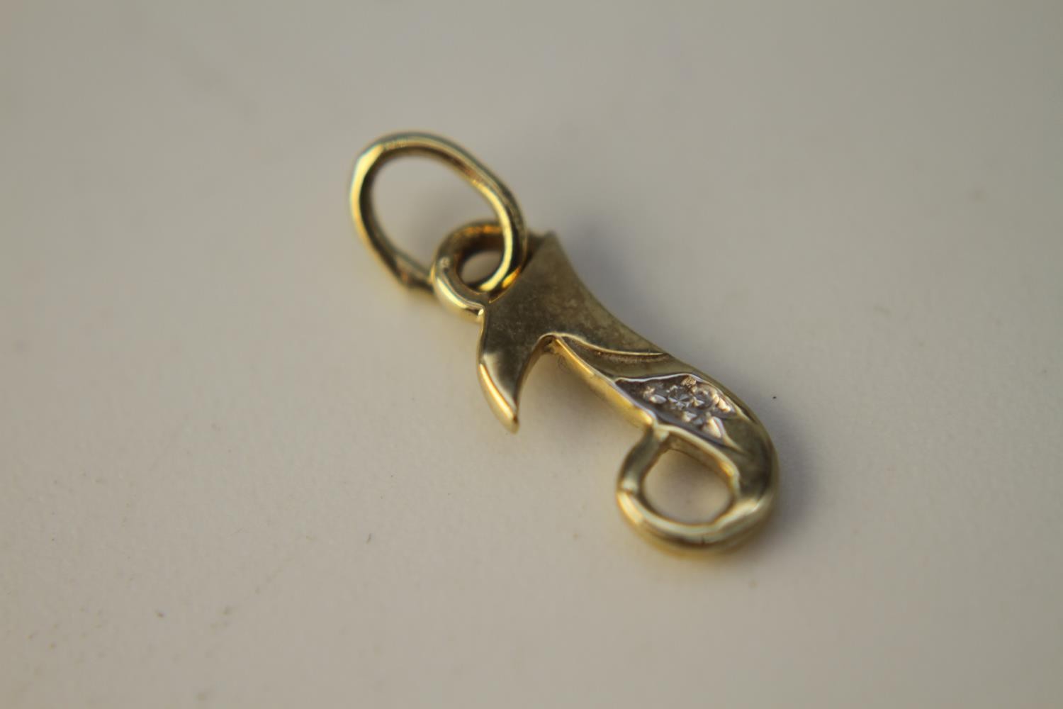 Four 14 carat yellow gold charms. Including a gold clog charm set with turquoise cabochons, a gold - Image 6 of 7