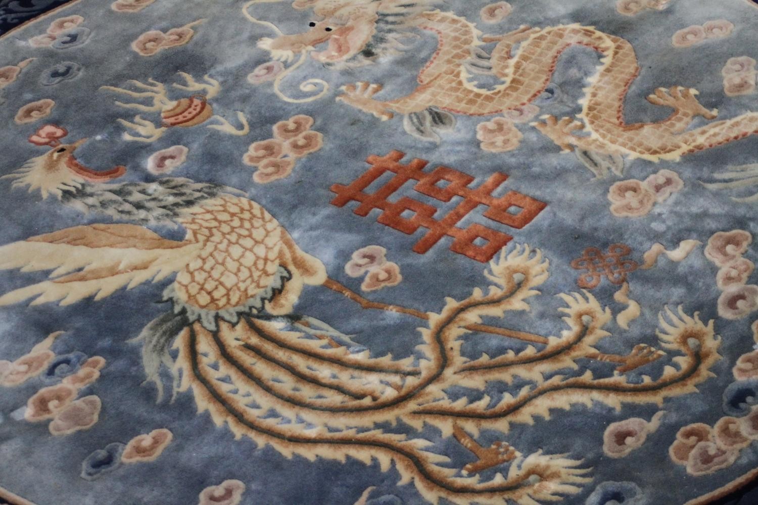 A Chinese carpet with chasing dragon and character motifs on a powder blue ground within a - Image 2 of 8