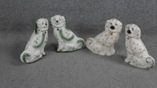 Two pairs of Staffordshire style ceramic spaniels. One pair with Blakeney stamp to bases. H.21 W.