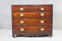 A 19th century mahogany chest of drawers with shaped apron and bracket feet resting on casters. H.88