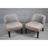 A pair of contemporary vintage style tub chairs in piped calico upholstery on tapering ebonised