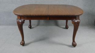 A large late 19th century mahogany extending dining table with three extra leaves, the rounded