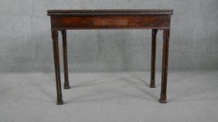 A Georgian mahogany tea table with carved and moulded edge fitted with frieze drawer and gateleg