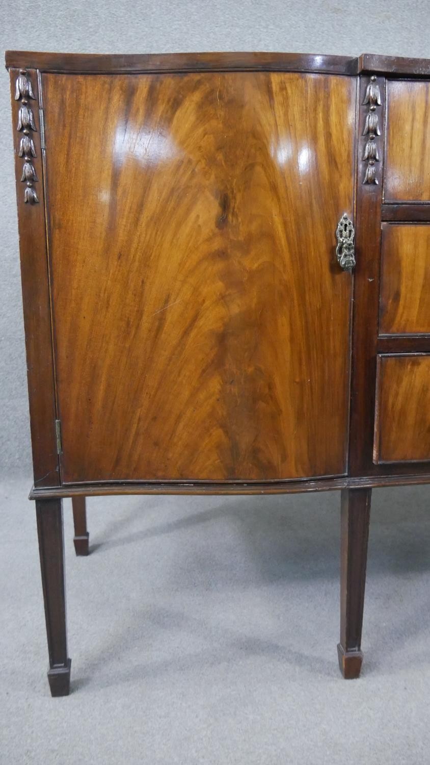 A Georgian style flame mahogany sideboard with husk carved decoration on square tapering supports. - Image 6 of 8