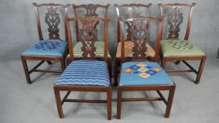 A set of six 19th century mahogany dining chairs with carved and pierced splat backs above drop in