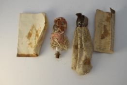 Two 19th century blown glass miniature bottles in the shape of dolls with painted features, cork and
