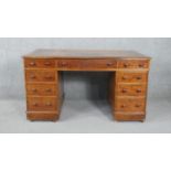 A Victorian mahogany three section pedestal desk with inset gilt tooled leather top on plinth