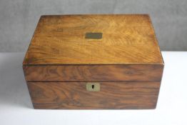 A 19th century walnut jewellery box with lined and fitted interior. H.14 W.30 D.22 cm.