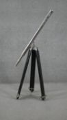 A reproduction chrome telescope on ebonised adjustable tripod base. H.93 W.87cm