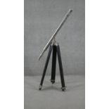 A reproduction chrome telescope on ebonised adjustable tripod base. H.93 W.87cm