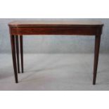 A 19th century mahogany and satinwood strung foldover top tea table on square tapering gateleg